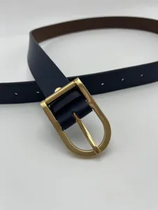 Close-up view of the metallic pin buckle and textured leather strap details.