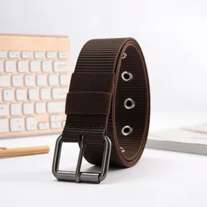 Close-up detail of a brown canvas belt with metal pin buckle and eyelets for daily use.