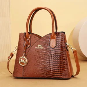 Dettaglio borsa a mano coccodrillo verniciato marrone, elegante borsa a tracolla donna.