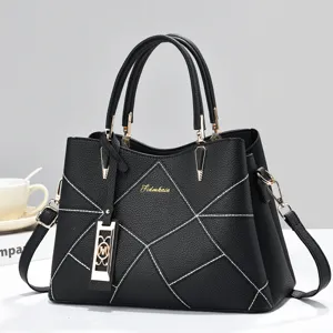 Black geometric stitched women shoulder handbag detail, elegant gold hardware design view.