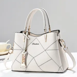 White fashion tote bag large capacity PU leather shoulder crossbody bag with geometric design.