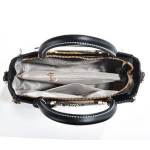 Interior detail view of black and white women handbag with multi-compartment zipper design
