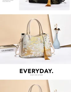 Elegant embroidered women tote bag with top handles and tassel pendant, stylish shoulder bag.