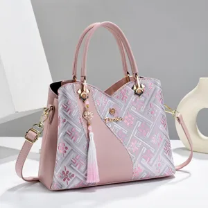 Pink embroidered women handbag with top handle and tassel detail, stylish shoulder crossbody bag.