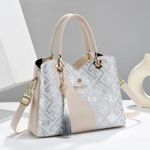 Detail view of the elegant women's tote bag, featuring intricate woven pattern and tassel.
