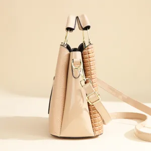 Women PU leather bucket handbag, multi-texture patchwork design, stylish shoulder bag.