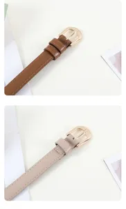 Détails en gros plan d'une ceinture fine en cuir pour femme avec boucle dorée chic.