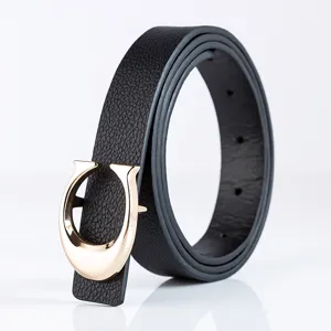 Close-up detail of a women's black leather belt featuring a sleek metallic gold C buckle.