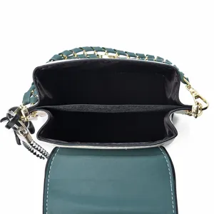 Women's shoulder crossbody bag top view showing interior compartments and chain strap.