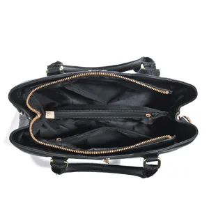 Black leather handbag interior detail, large capacity multi-compartment tote bag design.