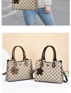 Detailed view of women fashion shoulder handbag featuring classic monogram pattern and charm.