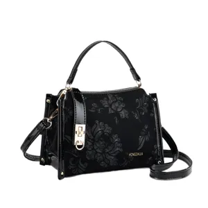Black floral embossed women handbag with secure lock closure, top handle and shoulder strap.