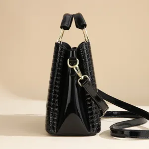 Black patent PU leather crocodile texture bucket bag with gold hardware and shoulder strap.