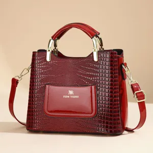 Red patent leather handbag for women, elegant crocodile pattern tote with shoulder strap.