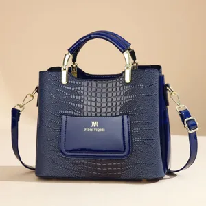 Blue patent leather handbag with crocodile pattern, gold hardware and shoulder strap for women.