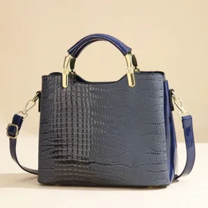 Blue crocodile pattern women handbag detail showing texture, PU leather and gold hardware.