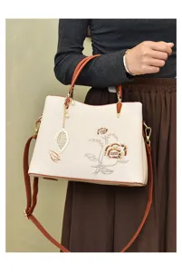 Chic floral embroidered handbag with top handle and adjustable crossbody strap for women.