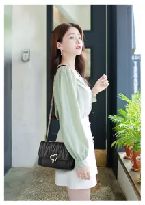 Stylish women's black shoulder bag with gold chain and sweet heart lock for daily wear.