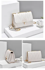 White quilted crossbody bag detail showing gold chain and heart lock design for women.