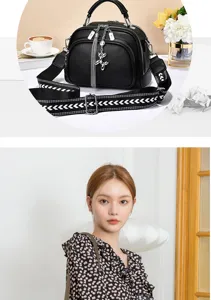 Detailed view of stylish black women shoulder bag featuring wide strap and cute charm.