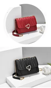 Detailed view of women crossbody bag featuring cute heart lock and metal chain strap.
