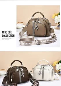 Stylish women shoulder bag with wide strap and cute metal pendant, casual commuter handbag.