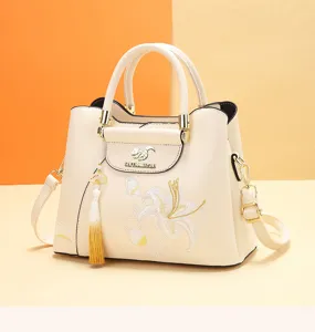 Close-up of the Chinese style embroidered handbag, featuring lily embroidery and tassel.