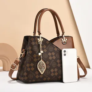 Elegante bolso de mano marrón a cuadros para mujer con asas, correa y colgante de hoja.
