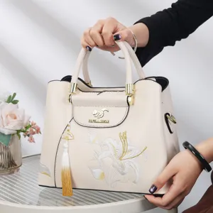 Classic Chinese style embroidered handbag for women, elegant beige design with tassel.