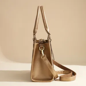 Metallic gold women tote bag top handle shoulder handbag stylish daily commute accessory.