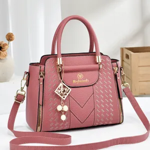 Fashionable pink women shoulder bag tote purse with vintage design and durable top handle.