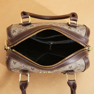 Detailed view of women's vintage Boston handbag, spacious interior with zipper pockets, stylish.