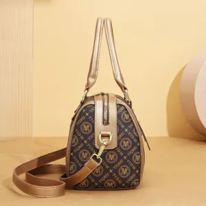 Retro monogram Boston handbag detail, stylish brown shoulder bag with gold hardware.