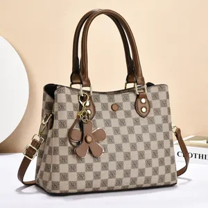 Stylish women's monogram shoulder bag with top handles and chic floral charm pendant for daily use.