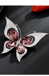 Exquisite crystal butterfly brooch featuring sparkling pink stones and shiny silver metal.