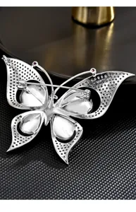 Exquisite silver crystal zircon butterfly brooch detail, elegant coat pin accessory.