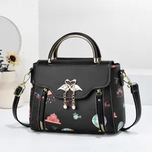 Black fashion women handbag detail, elegant swan clasp, colorful print crossbody bag.