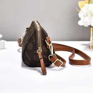 Stylish brown monogram crossbody bag with zipper closure and adjustable shoulder strap for women.
