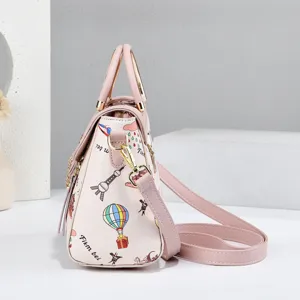 Stylish pink women handbag casual crossbody bag with doodle print and metal handle details.