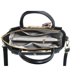 Detailed view of black women handbag interior, showing multi-compartment capacity and zipper pockets.