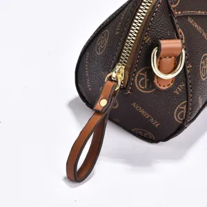 Detailed view of brown monogram leather handbag zipper, golden hardware and pull tab.