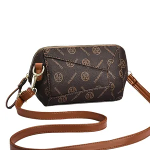 Brown monogram crossbody bag for women with adjustable tan strap and gold hardware.
