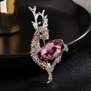 Elegant deer shape brooch with sparkling purple crystal and rhinestones, fine jewelry detail.