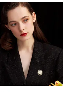 Exquisite crystal sunburst brooch detail, elegant sparkling rhinestone lapel pin accessory.