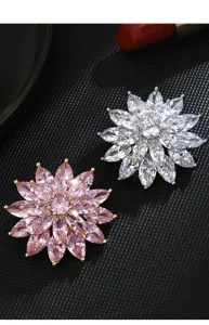 Close-up detail of luxury sparkling crystal snowflake brooch pins, exquisite micro-set zircon design.