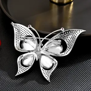 Elegant butterfly brooch featuring sparkling crystal zircons in silver tone design.