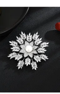 Detail view of exquisite copper micro-set zircon freshwater pearl snowflake brooch accessory.