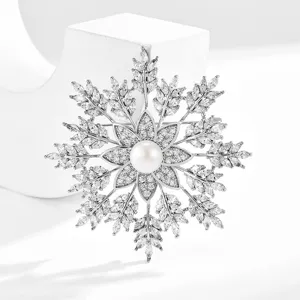 Snowflake brooch with micro-paved cubic zirconia and natural freshwater pearl.