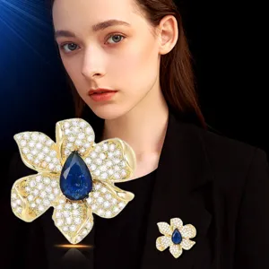 Elegant flower magnetic brooch with sparkling rhinestones and blue stone for shirt collar pin.