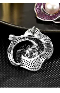 Exquisite lotus flower brooch with white pearl detail, elegant metal fashion jewelry accessory.